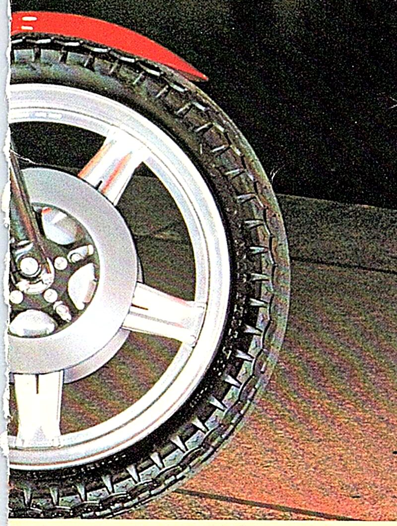 Close-up of a CBX Comstar wheel with its aluminum spokes and front tire.